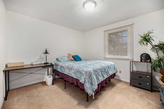 bedroom featuring light carpet