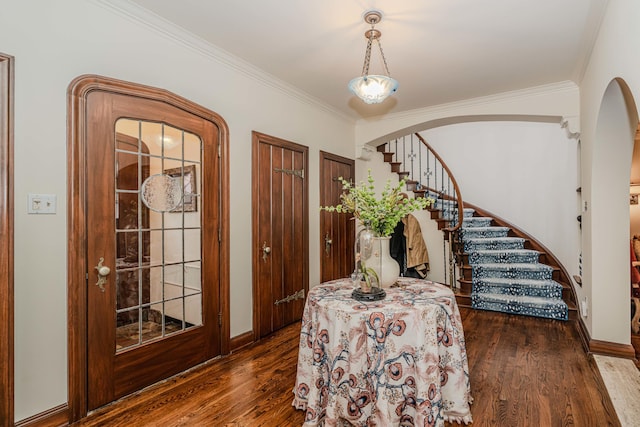 entryway with dark hardwood / wood-style floors and crown molding