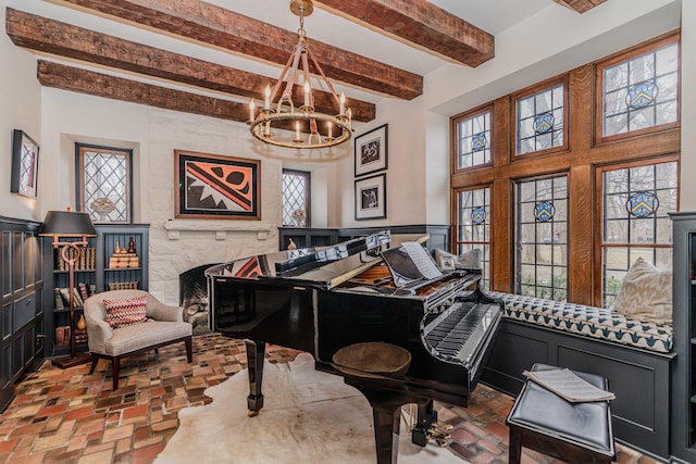 miscellaneous room with a notable chandelier, beamed ceiling, and plenty of natural light