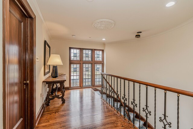 hall with ornamental molding and hardwood / wood-style flooring