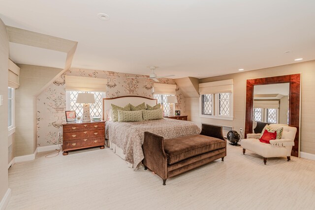 carpeted bedroom featuring ceiling fan and multiple windows