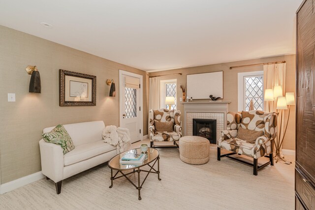 living room with a brick fireplace and light carpet