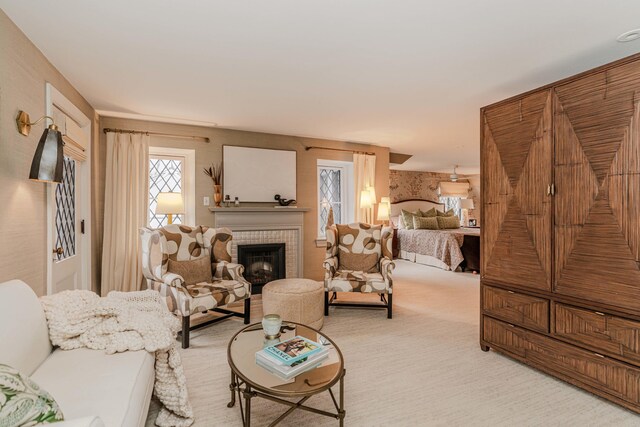 carpeted living room featuring a tile fireplace