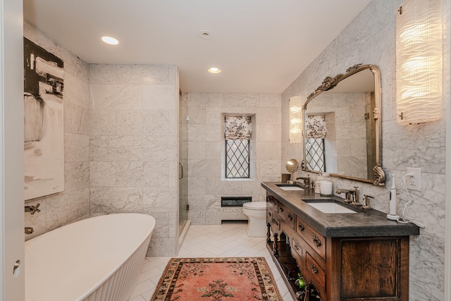 full bathroom featuring tile walls, tile patterned flooring, separate shower and tub, vanity, and toilet