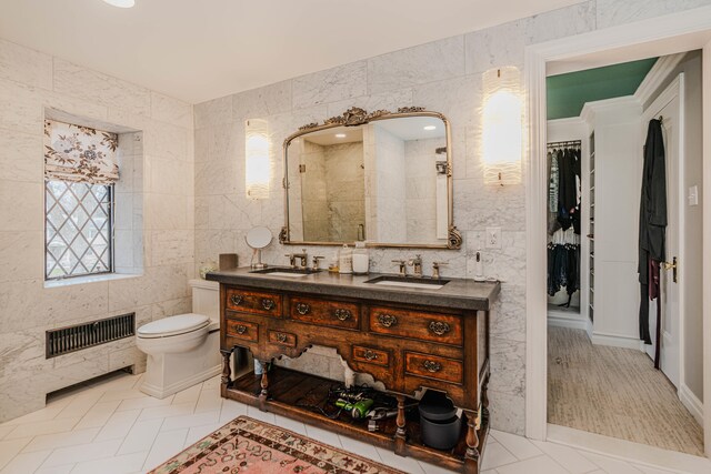 bathroom featuring vanity, an enclosed shower, tile patterned floors, tile walls, and toilet