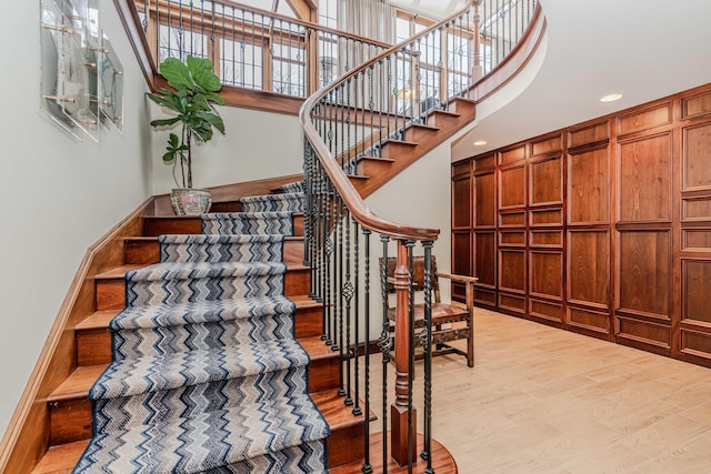 staircase with hardwood / wood-style flooring