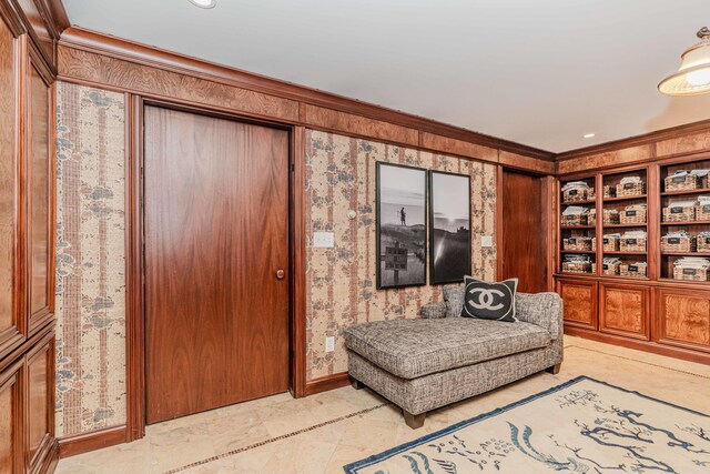 living area featuring ornamental molding