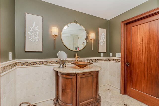 bathroom with vanity, tile walls, and tile patterned flooring