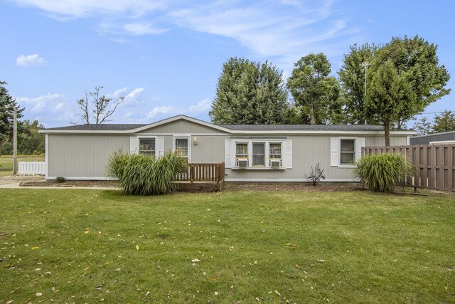 back of house with a lawn