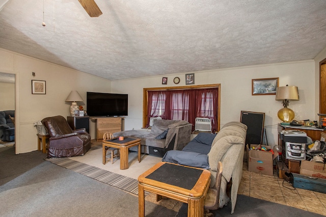 living room featuring a textured ceiling, carpet floors, and ceiling fan