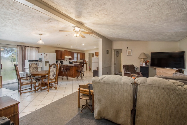 tiled living room featuring ceiling fan, beamed ceiling, and a textured ceiling