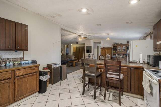 kitchen featuring a textured ceiling, decorative backsplash, light tile patterned floors, ceiling fan, and white range with electric cooktop