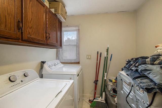 washroom featuring tile patterned flooring, washer and dryer, and cabinets