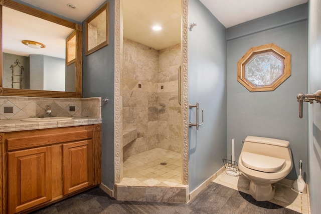 bathroom featuring a tile shower, tile patterned flooring, decorative backsplash, vanity, and toilet