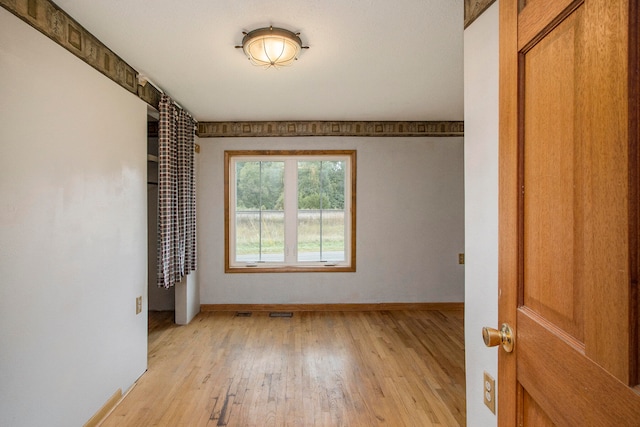 spare room with light hardwood / wood-style flooring