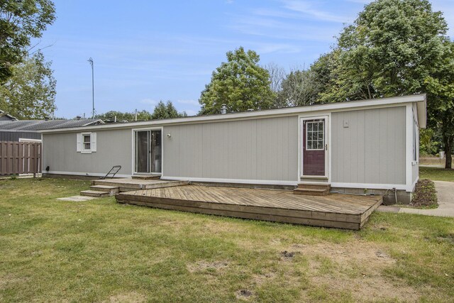 rear view of house featuring a yard