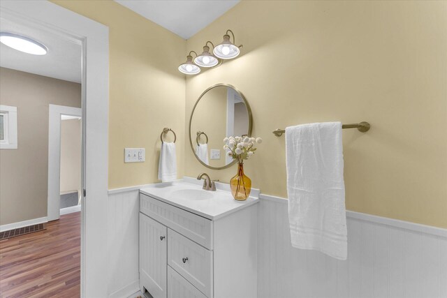 bathroom with vanity and hardwood / wood-style flooring