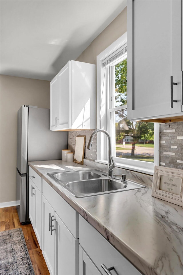 kitchen with white cabinets, sink, and dark wood-type flooring