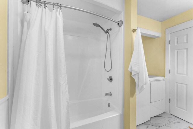 bathroom featuring washing machine and clothes dryer and shower / bath combo