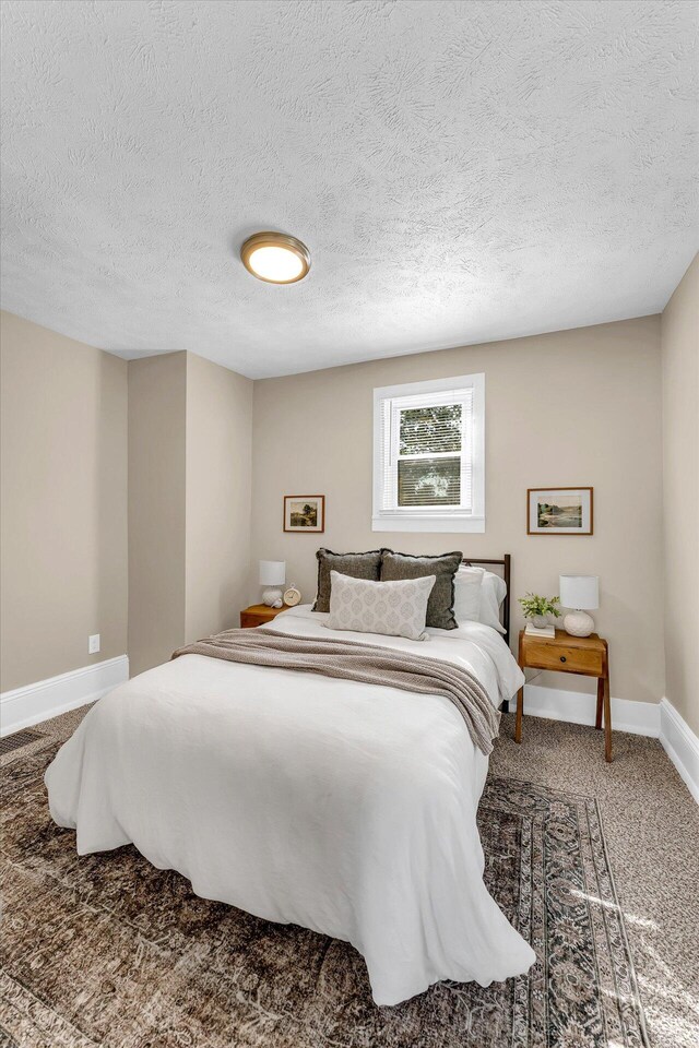 carpeted bedroom featuring a textured ceiling