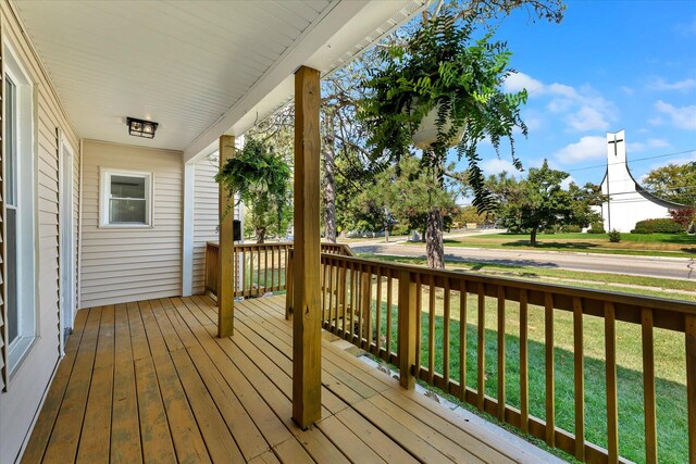 wooden terrace with a lawn