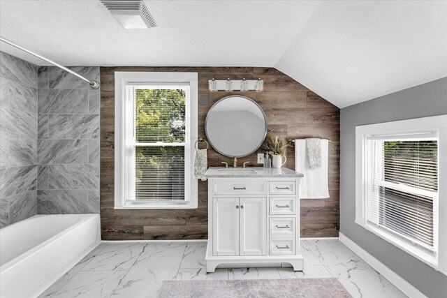 bathroom featuring shower / tub combination, vanity, and wood walls