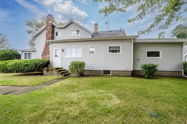 rear view of house with a lawn