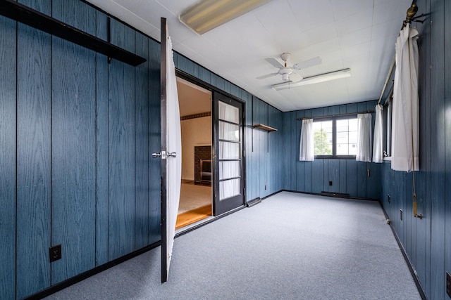 unfurnished sunroom featuring ceiling fan