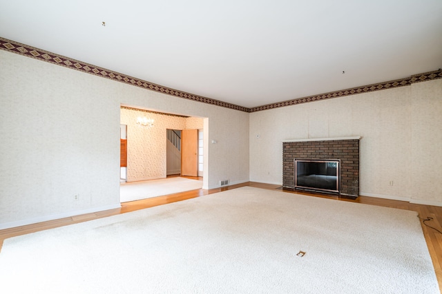 unfurnished living room featuring wood-type flooring and a fireplace