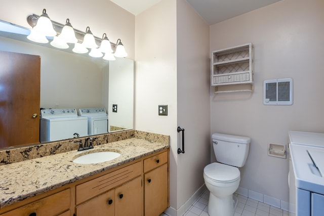 bathroom featuring washer and clothes dryer, tile patterned flooring, vanity, and toilet