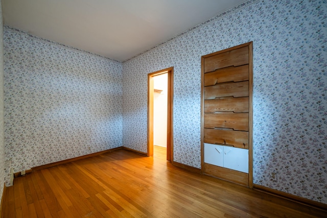 unfurnished bedroom with hardwood / wood-style flooring