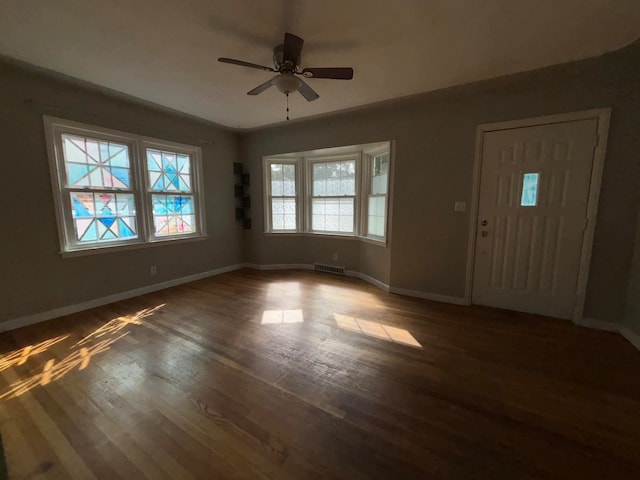 foyer entrance with ceiling fan and dark hardwood / wood-style floors