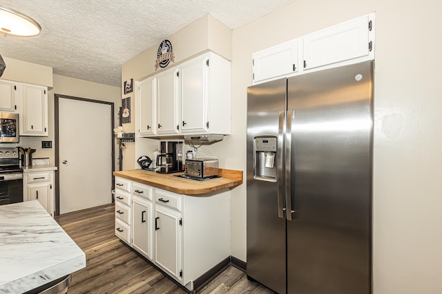 kitchen with butcher block countertops, white cabinetry, appliances with stainless steel finishes, and dark wood-type flooring