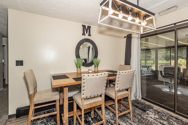 dining space with a textured ceiling