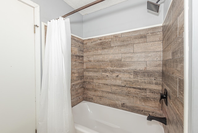 bathroom featuring a textured ceiling and shower / bath combination with curtain