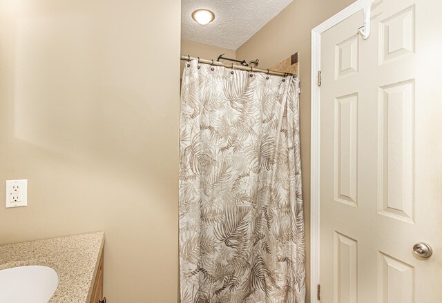 bathroom featuring vanity and a textured ceiling