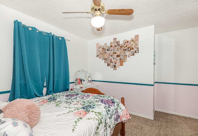 carpeted bedroom with ceiling fan and a textured ceiling