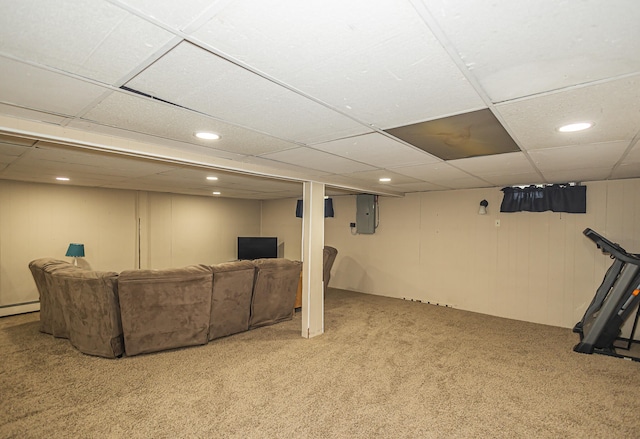 basement featuring light carpet, electric panel, a drop ceiling, and a baseboard radiator