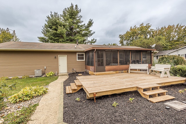 back of property with a deck and a sunroom