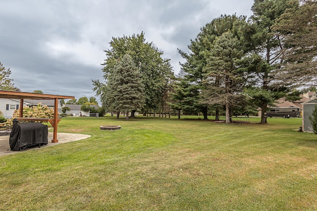 view of yard with a fire pit