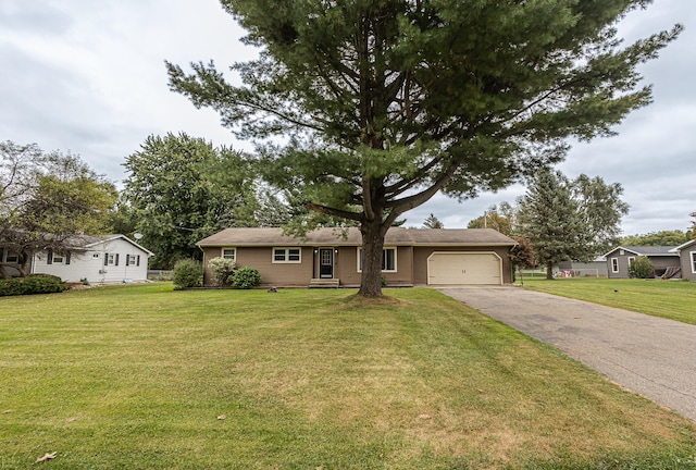 ranch-style house featuring a garage and a front lawn