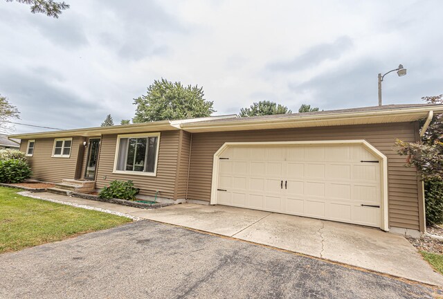 single story home with a garage