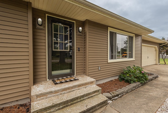 view of exterior entry with a garage