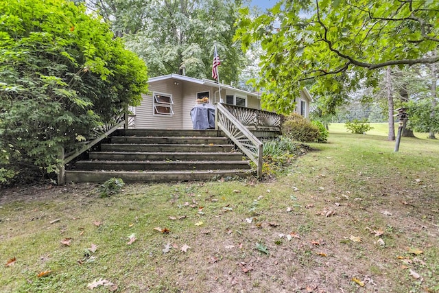 back of house with a lawn and a wooden deck