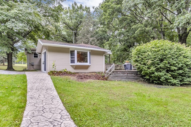 view of side of property with a lawn