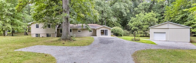 split level home with an outdoor structure, a garage, and a front yard