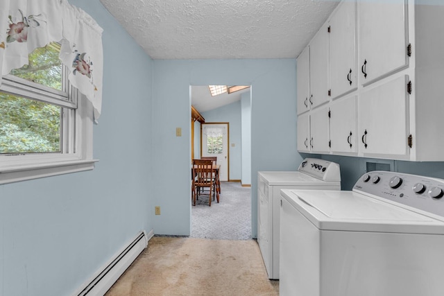 laundry area with cabinets, a textured ceiling, washer and dryer, light carpet, and a baseboard radiator