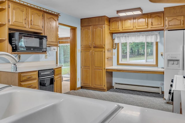 kitchen with plenty of natural light and a baseboard radiator