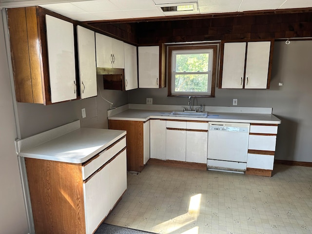 kitchen featuring sink, white dishwasher, and white cabinets