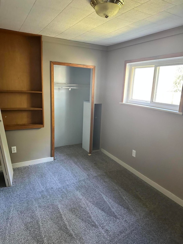 unfurnished bedroom featuring carpet flooring and a closet